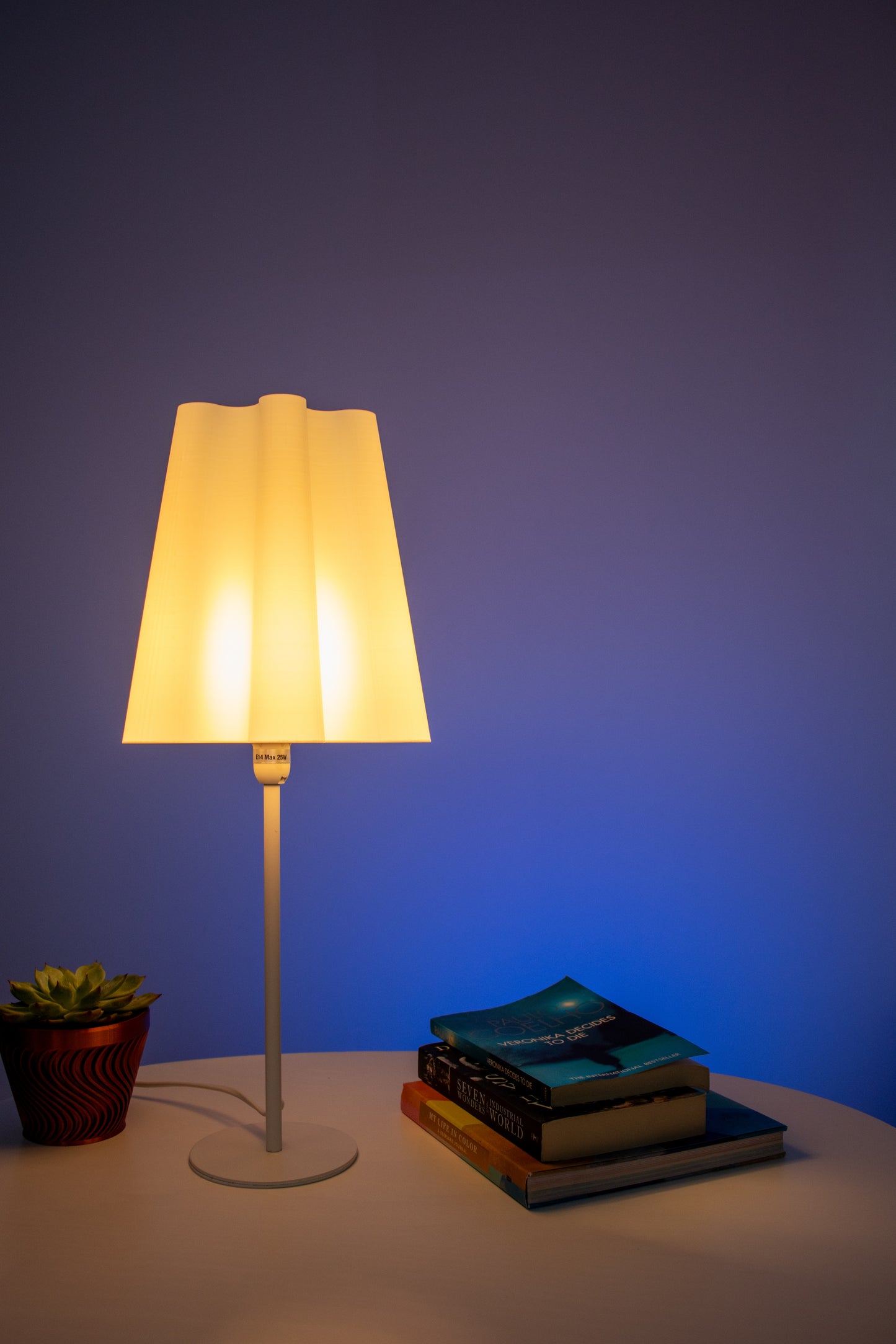 An aesthetic lamp with a wavy conical lamp shade in powered on state to elevate the looks of a modern minimalistic living space. The light colour is warm for reducing eye strain.